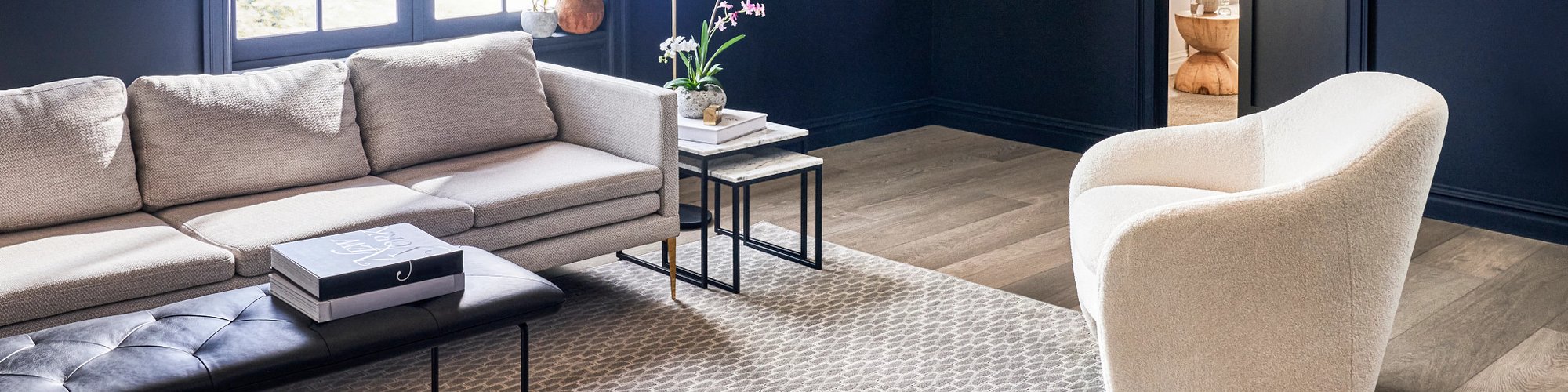 white armchair and beige couch on a beige rug