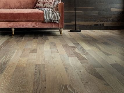 brown couch an a brown hardwood floor