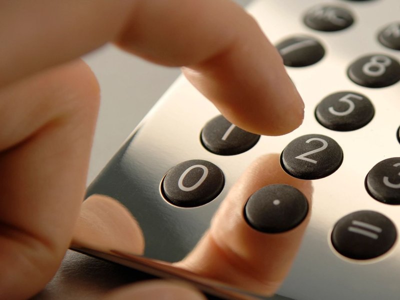 person dialling phone from Er Walker Flooring Specialists in Fayetteville, GA